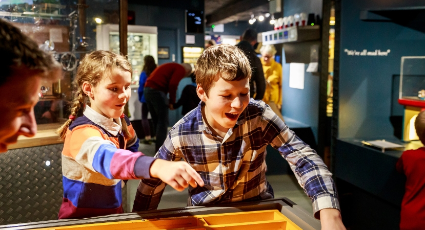 Children playing with a puzzle game in The MAD Museum